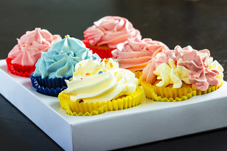 Set different delicious homemade cupcakes butter cream paper delivery box. Close up.の写真素材