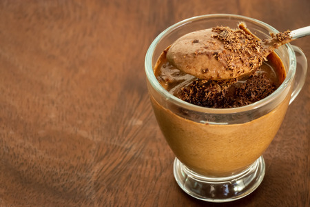 Healthy dessert chocolate pudding serving cups wooden cutting boarding. Selective focus.の写真素材