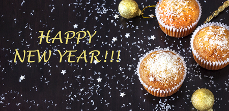 New year and Christmas concept banner with homemade cocnut muffin dark background.. Top view.  Selective focus.の写真素材