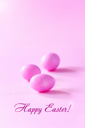 Three small pink eggs on pink background. Easter celebrate concept. Copy space.の写真素材