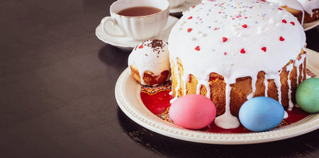 Easter cake and colorful eggs close-up. Happy Easter family breakfast concept. Selective focus.