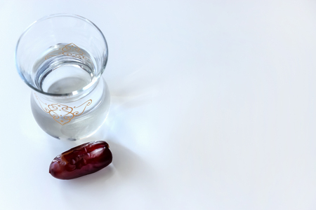 Organic dried dates and glass of water. Ramadan concept. Top view.の写真素材