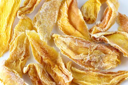 Sweet raw organic dried mango. Flatlay. White background. Isolated.の写真素材