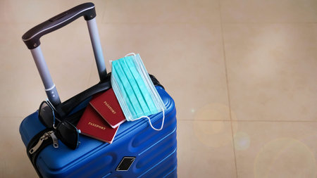 Blue suitcase collected for travel during the  pandemic. Concept holidays and trips. Banner size....