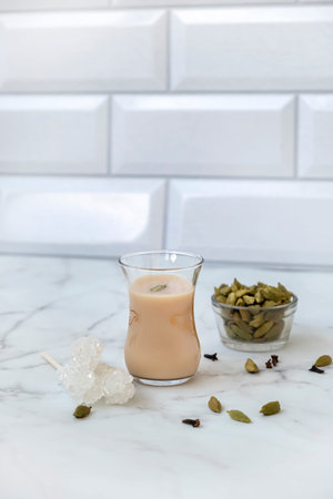 Traditional indian and middle eastern hot drink masala tea or karak chai with spice and milk. exotic...
