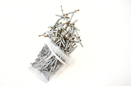 isolate on white background, a bucket with metal nails lying on its sideの写真素材