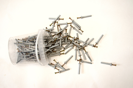 isolate on white background, a bucket with metal nails lying on its sideの写真素材