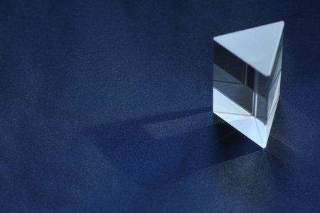 3d render of a glass object on a blue background with shadow
