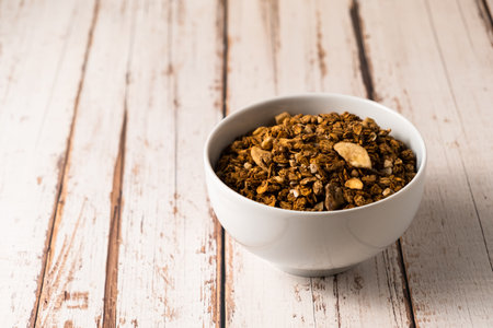 energy fitness breakfast. Chocolate granola with dried fruits, various granola bars on a wooden background.の写真素材
