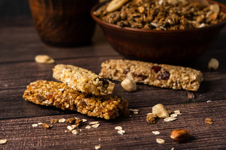 energy fitness breakfast. Chocolate granola with dried fruits, various granola bars on a wooden background.の写真素材