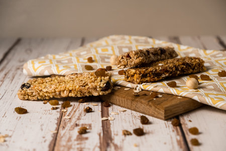 energy fitness breakfast. Chocolate granola with dried fruits, various granola bars on a wooden...