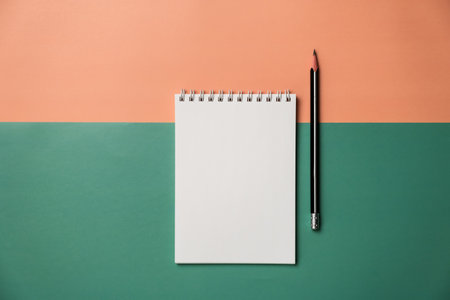Blank notepad and pencil on color background. Mockup for designの写真素材