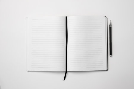 top view of open notebook and pen isolated on white, business conceptの写真素材