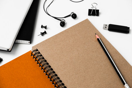 Top view of office desk table with blank notebook, stationery and pen.の写真素材