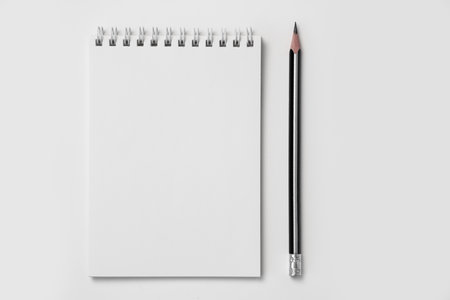 Blank notepad with pencil on white background. Mock upの写真素材