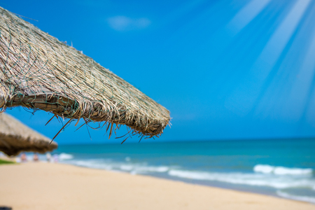 Beach beautiful thatched umbrellas and bright turquoise sea, great recreation and relaxation. tropical paradise. hot countriesの写真素材