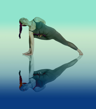 young girl performs different poses of yoga, flexible beautiful model on a white background. meditation and asanas. the harmony of body and spiritの写真素材