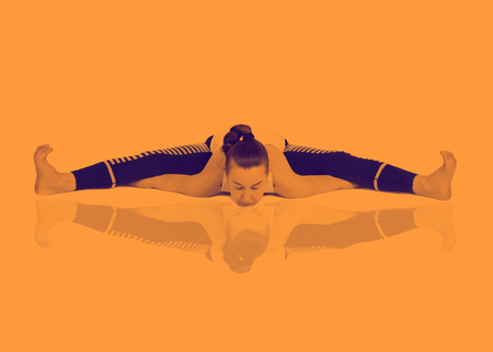 young girl performs different poses of yoga, flexible beautiful model on a white background. meditation and asanas. the harmony of body and spiritの写真素材