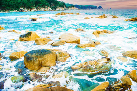 coastline, beautiful beach stones and blue waves. lots of sun and beautiful nature.の写真素材