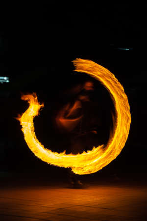 fire fire show, a night performance with a burning fire. flames in the night.の写真素材