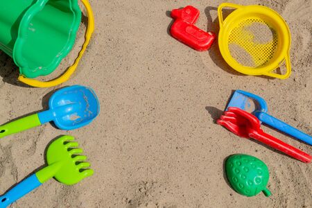 children's sand toys outdoor. backgraund wiht shovel, rake,molds and bucket.の写真素材