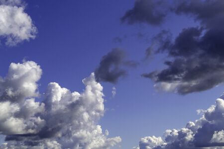 White and gray clouds in sunny sky. Ð¡ontrast bright backgroundの写真素材