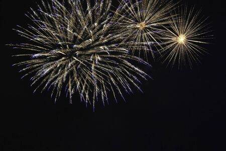 Veriety colorful fireworks on the night sky background. Salute with yellow flashes. holiday and fun conceptの写真素材