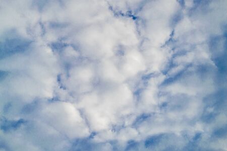 Background with blue sky and many clouds. A lot of little white clouds.の写真素材