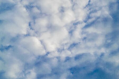 Background with blue sky and many clouds. A lot of little white clouds.の写真素材