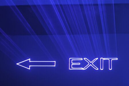 Abstract background with blurred ray of light. Lighting and spotlights lines, stage light and smoke. And the luminous inscription Exit. Classic blue, trend color. Color of the yearの写真素材