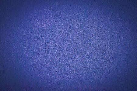 Blue painted wall with vignetted knots.  Old colored stone wall texture.の写真素材
