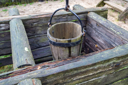 Old wooden well and a wooden bucket. The concept of rural areas and recreation in the village.の写真素材