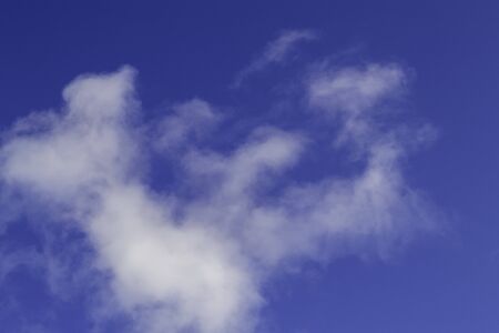 Bright white clouds on blue sky. Beautiful background.の写真素材