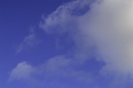 Bright white clouds on blue sky. Beautiful background.の写真素材
