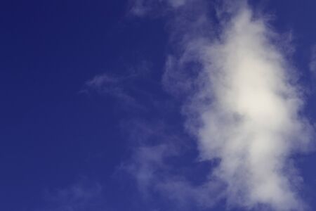 Bright white clouds on blue sky. Beautiful background.の写真素材