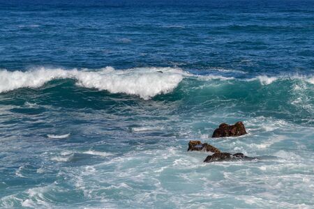 Canary islands in the Atlantic Ocean. Waves on the black rocky coast volcanic Tenerife Island.の写真素材