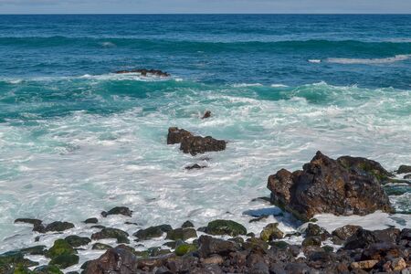 Canary islands in the Atlantic Ocean. Waves on the black rocky coast volcanic Tenerife Island.の写真素材