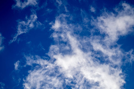 Beautiful nature background. Bright white clouds on blue sky. Spring sunny day. 