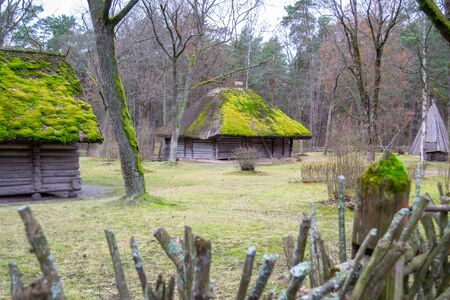 Village in museum. Old wooden houses. View with window, front door and with moss on the roof.の写真素材