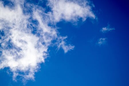 Bright white clouds on blue sky. Spring sunny day. Beautiful nature background.の写真素材