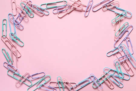 Multi-colored paper clips laid out in the form of a frame. Layout and flat lay with place for text. Concept back to school.の写真素材