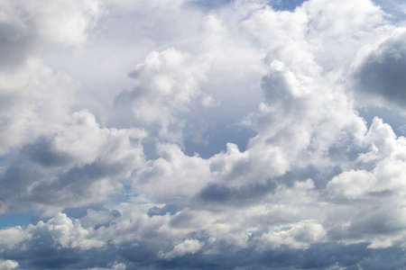 The blue sky shines through the clouds. Beautiful white cumulus clouds in the blue skyの写真素材