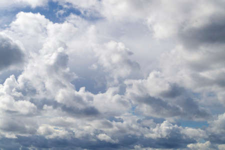 Beautiful white cumulus clouds in the blue sky. Small gaps in the blue skyの写真素材