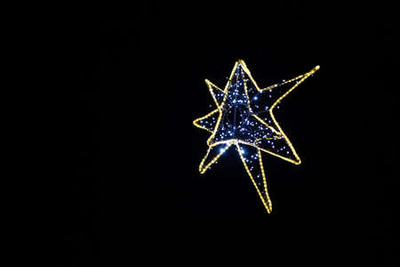 Decorative Christmas star from led lamps on black background. Christmas and new year concept.の写真素材