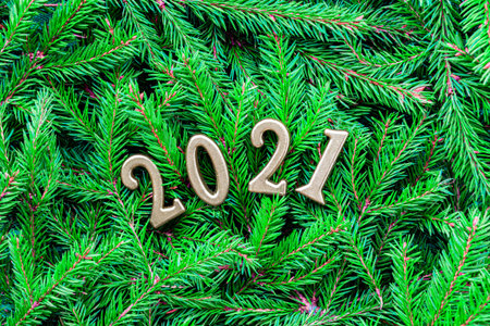 Holiday concept New Year and Christmas. Gold numbers 2021 on a background of Christmas tree...