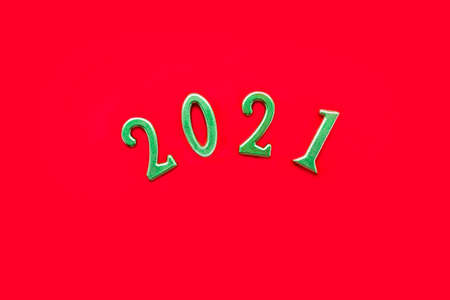 Golden numbers 2021 on solid red background. New Year and Christmas holiday concept. Flat lay, copy space.の写真素材