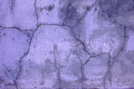 Veolet old concrete wall with many long cracks. Urban style. Copy space. Cracked texture, abstract background.の写真素材