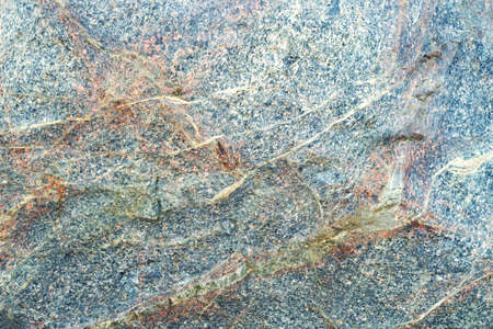 Blue, orange and white stone texture. Rough granite surface pattern, natural mineral stone wall background. Copy space, place fot text.の写真素材