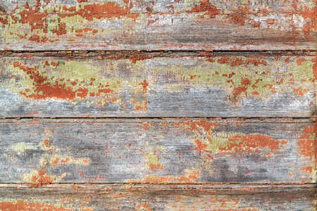 Brown boards. Aged dilapidated wall. Old, cracked and peeled paint. Rustic background. Place for text, copy space.の写真素材