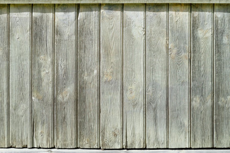 Old fence. Vertical wooden planks close up. Gray-white wall of planks. Place for text, copy space, background, pattern.の写真素材